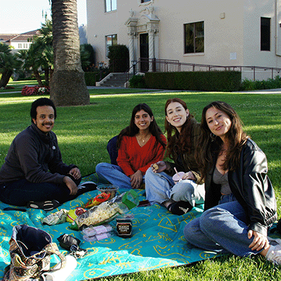 Four students on the lawn outside Varsi Hall