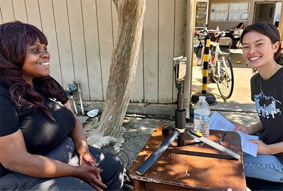 A Public Health capstone student interviews a woman experiencing homelessness.