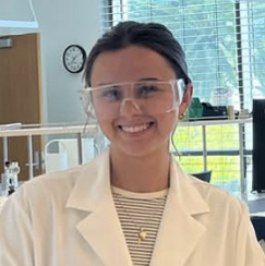 Isabella Matusich in lab wearing protestive eyeware and lab coat.
