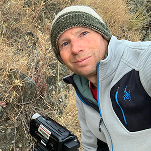 Andrea Pappas (Art & Art History) looks through a magnifying glass
