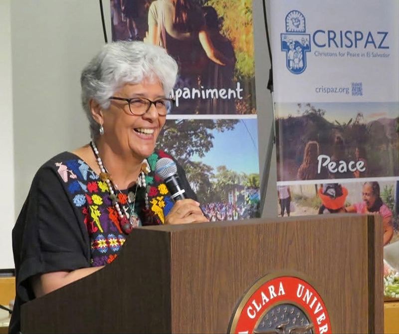 Ana María Pineda smiling at the podium and accepting the 2025 Peter Hinde CRISPAZ Peace Award