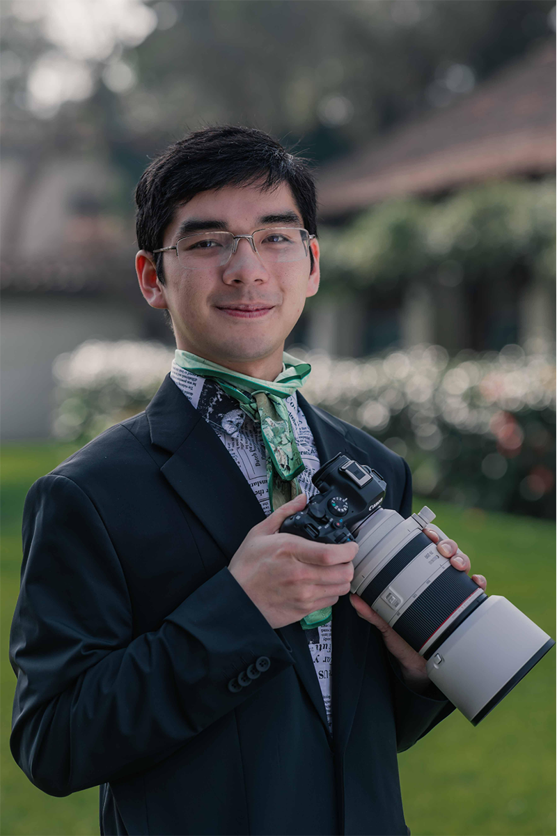 Dylan Ryu holding a large lens camera